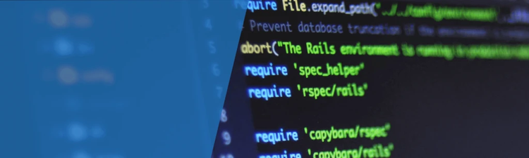 Close-up of a computer screen with green-highlighted source code on a dark background and a blue overlay on the left