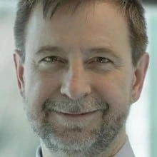 Jeffrey Snover wearing glasses and smiling at the camera