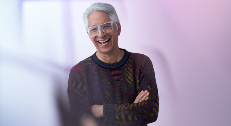 A smiling older man with gray hair