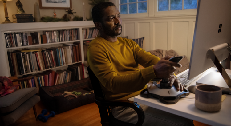Person sitting at a desk in a cozy living room