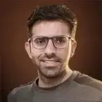 a man wearing glasses and looking at the camera