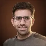 a man wearing glasses and looking at the camera