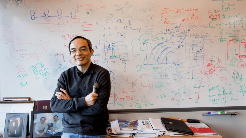 a man standing in front of a whiteboard