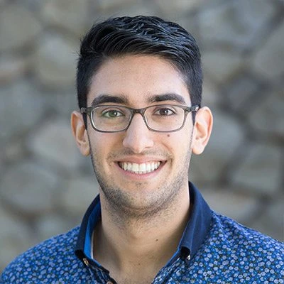 Armon Dadgar wearing glasses and smiling at the camera