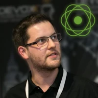 a man wearing glasses and looking at the camera