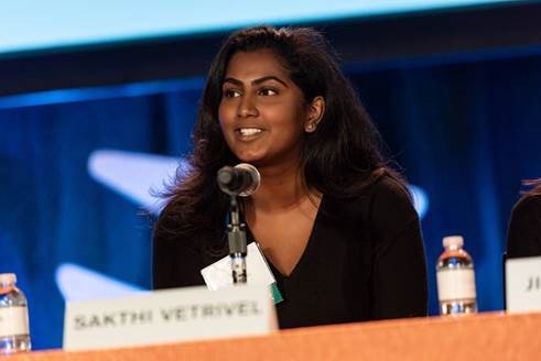 a woman speaking into a microphone