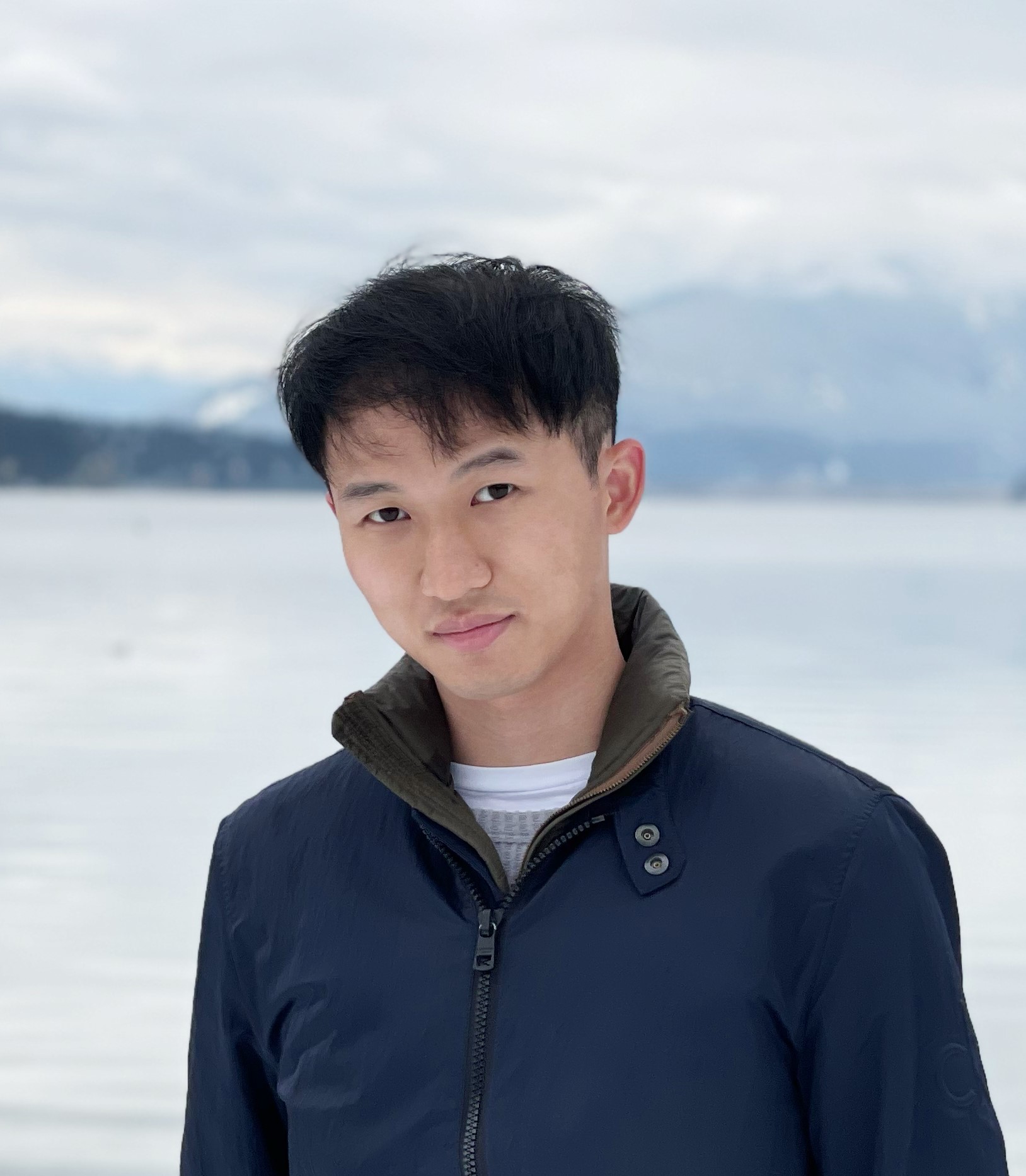 a man standing in front of a body of water