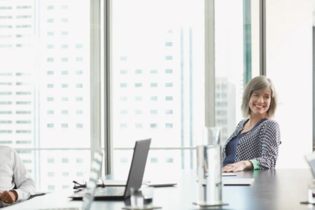 Women smiling at conference table