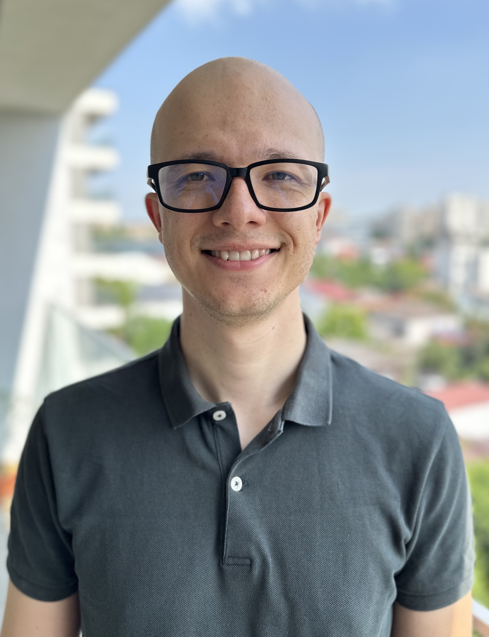 Person wearing glasses and smiling.