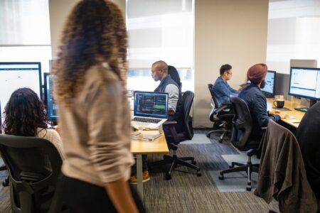 A team of practitioners work in a shared office space.