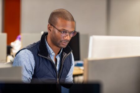 A man looks at a computer screen.